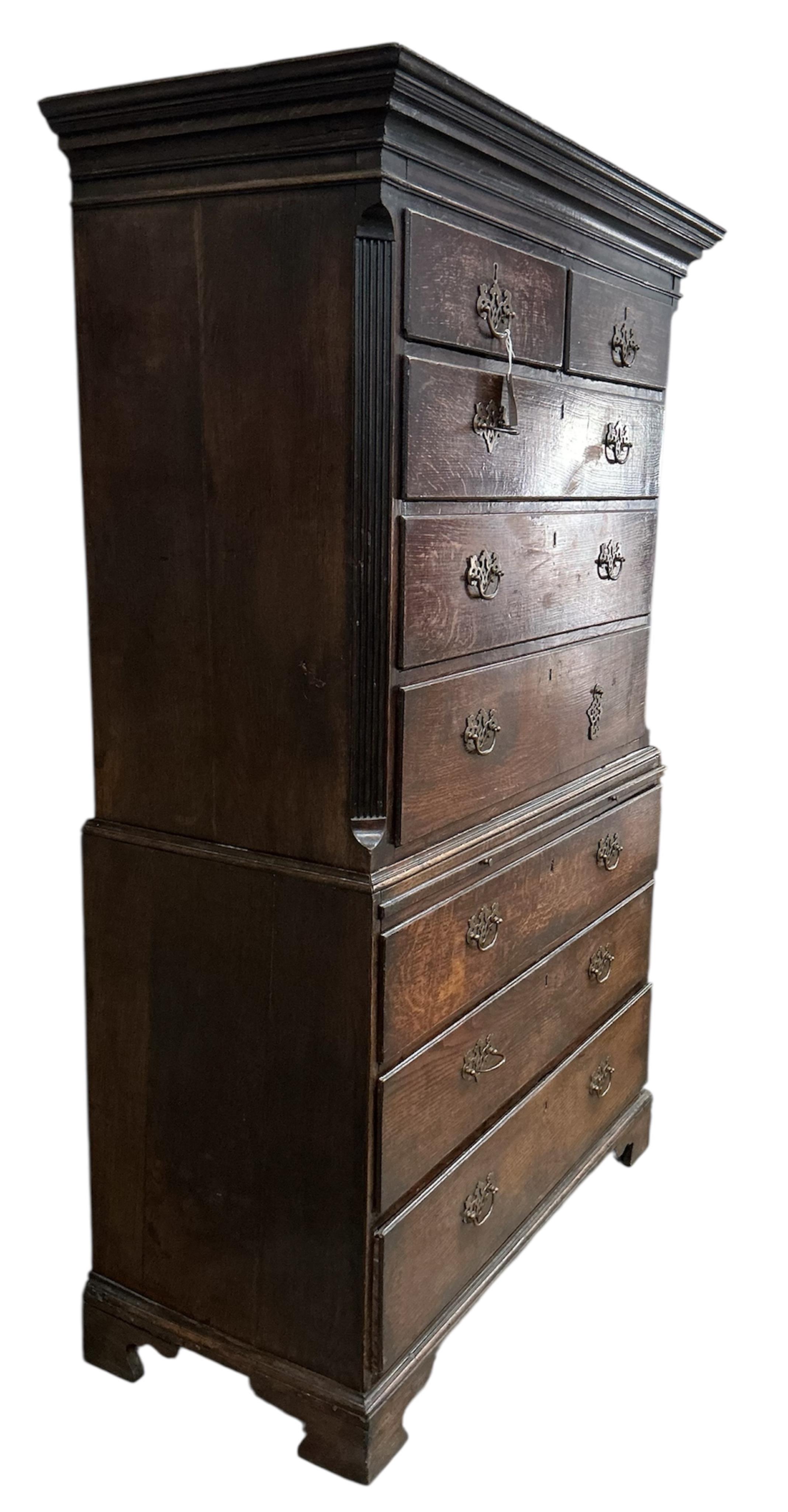 A George III oak chest on chest with slide, width 106cm, depth 52cm, height 186cm